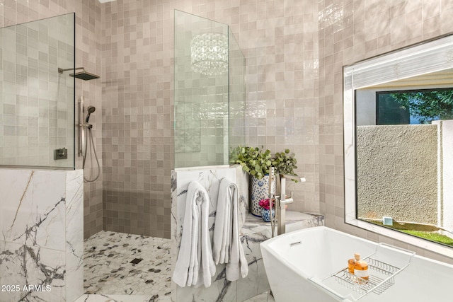 bathroom with tile walls and independent shower and bath