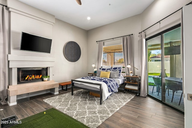 bedroom featuring dark wood-type flooring and access to exterior