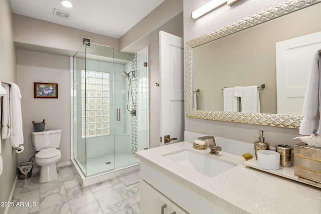 bathroom featuring vanity, toilet, and an enclosed shower