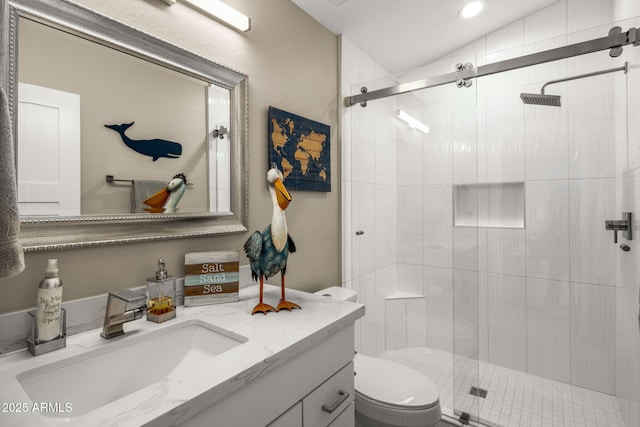 bathroom with vanity, an enclosed shower, and toilet