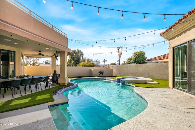 view of pool with a patio area and an in ground hot tub