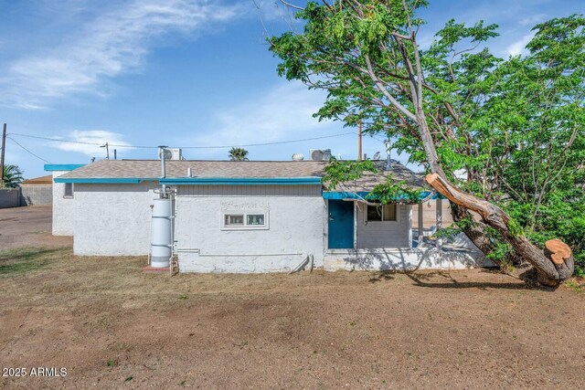 721 W Cinnabar Ave, Phoenix, AZ 85021 - view of side of home featuring a shingled roof and stucco siding