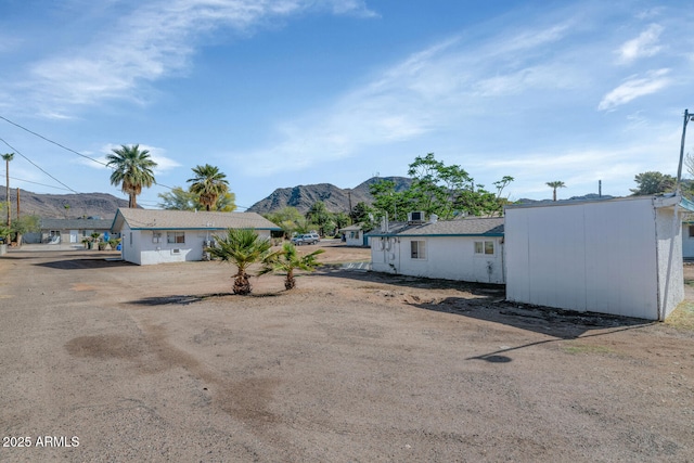721 W Cinnabar Ave, Phoenix, AZ 85021 - view of front of house with driveway, an outbuilding, and a mountain view