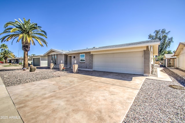 ranch-style home with concrete driveway and a garage