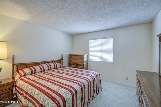 bedroom featuring carpet flooring and a textured ceiling