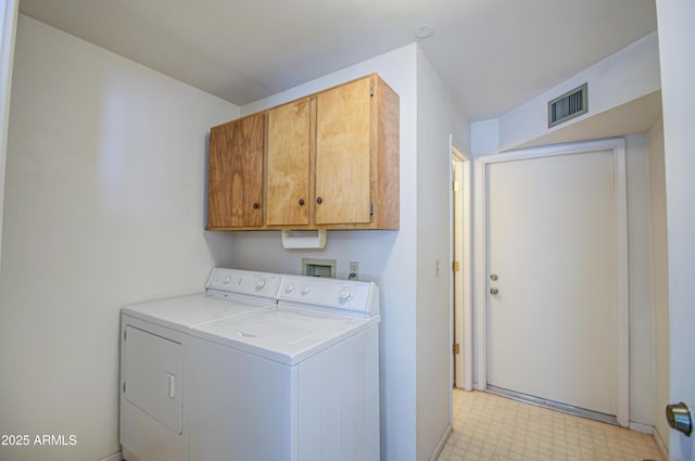 washroom with independent washer and dryer, visible vents, cabinet space, and light floors