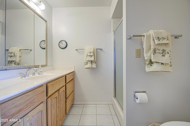 bathroom featuring tile patterned flooring, vanity, toilet, baseboards, and an enclosed shower