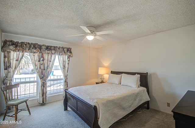 bedroom with baseboards, a ceiling fan, carpet, and a textured ceiling
