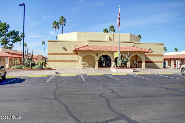 view of property featuring uncovered parking