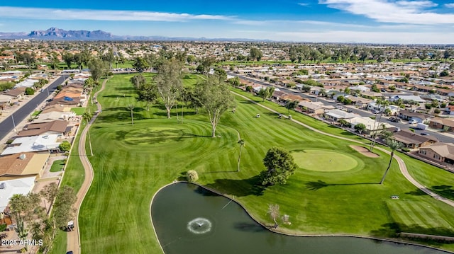 drone / aerial view with golf course view, a water and mountain view, and a residential view