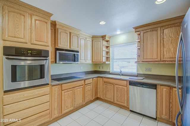 kitchen featuring light brown cabinets, a sink, open shelves, appliances with stainless steel finishes, and light tile patterned floors