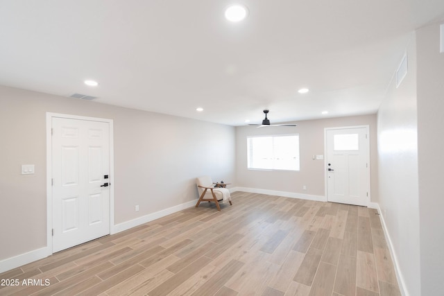 entrance foyer with ceiling fan and light hardwood / wood-style flooring