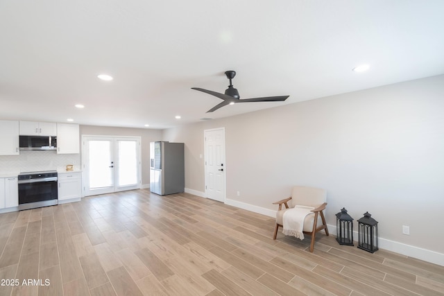 unfurnished room featuring french doors, ceiling fan, and light hardwood / wood-style floors