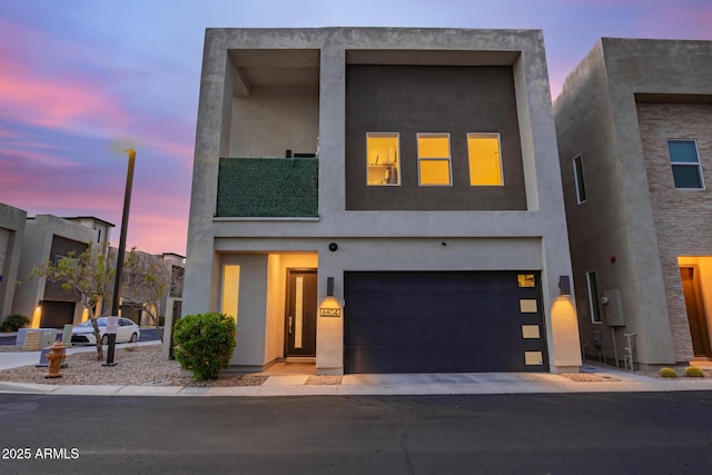 contemporary home featuring stucco siding and an attached garage