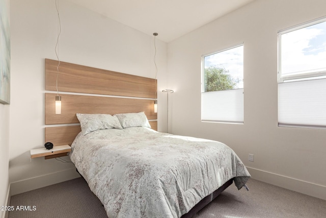 bedroom with baseboards and carpet