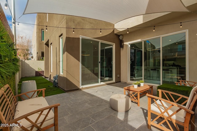 view of patio featuring fence