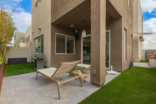 view of patio featuring a grill and fence