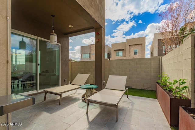 view of patio / terrace with a garden and fence