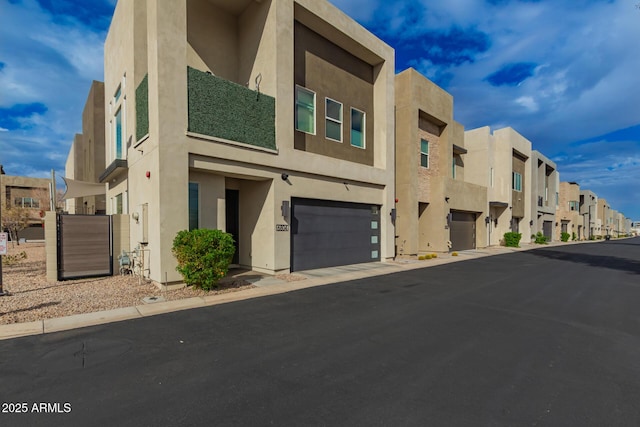 view of building exterior with an attached garage and a residential view