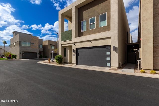 view of front of house with stucco siding and a garage