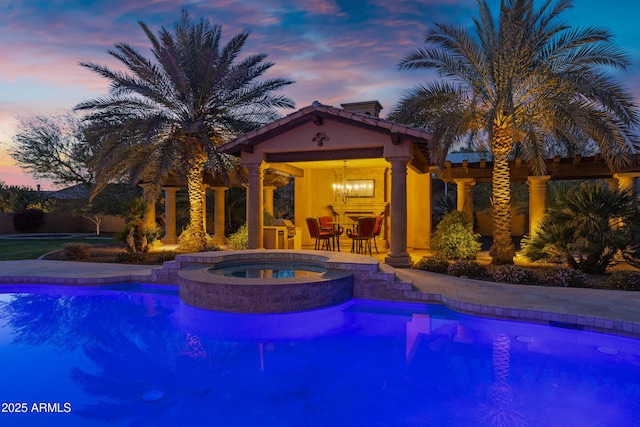 10894 E Turquoise Ave, Scottsdale, AZ 85259 - pool at dusk featuring an outdoor pool, a patio, and an in ground hot tub