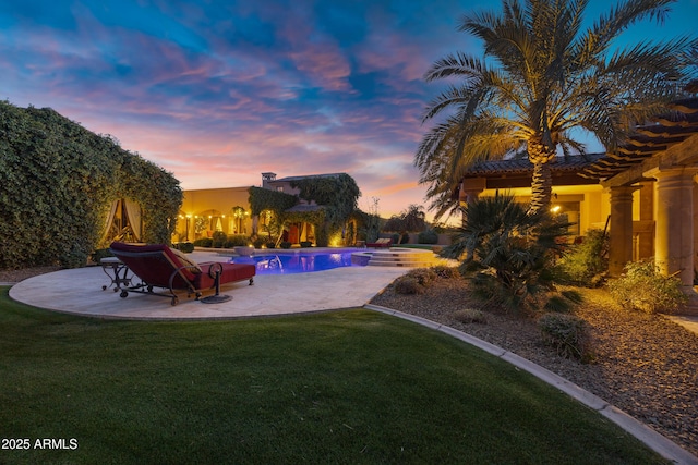 10894 E Turquoise Ave, Scottsdale, AZ 85259 - pool at dusk featuring a patio area, an outdoor pool, and a yard