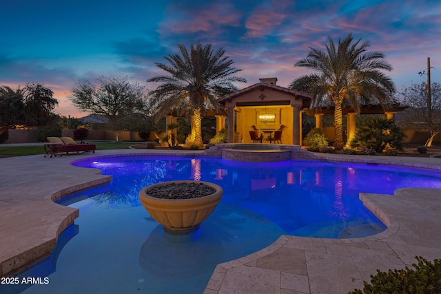 10894 E Turquoise Ave, Scottsdale, AZ 85259 - view of swimming pool featuring a pool with connected hot tub, an outdoor structure, a patio, and a storage structure