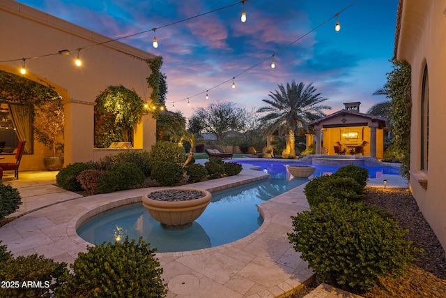 10894 E Turquoise Ave, Scottsdale, AZ 85259 - pool at dusk featuring a patio area, an outdoor pool, and a hot tub