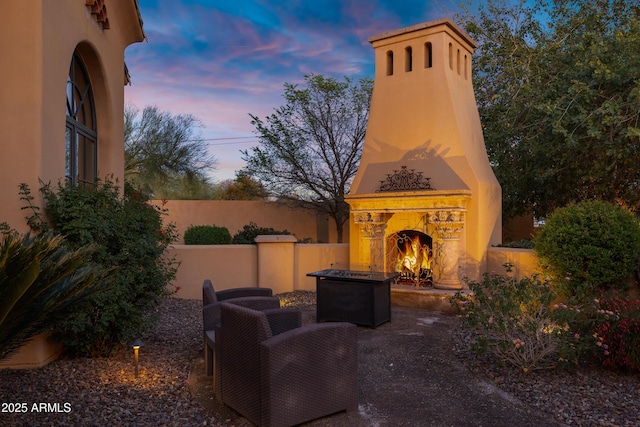 10894 E Turquoise Ave, Scottsdale, AZ 85259 - view of patio / terrace with a lit fireplace and fence