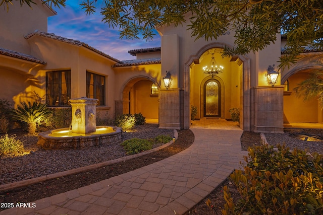 10894 E Turquoise Ave, Scottsdale, AZ 85259 - view of exterior entry with a tile roof and stucco siding