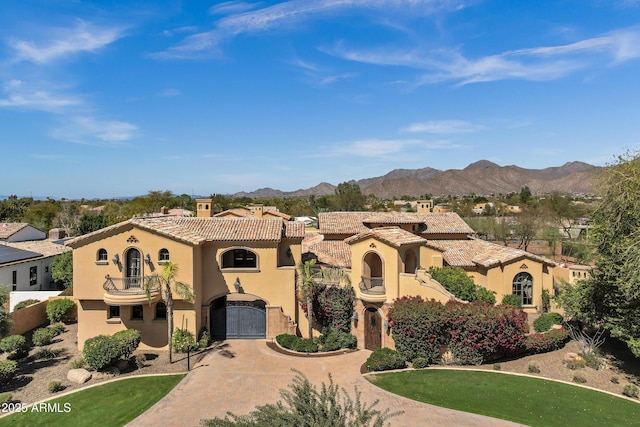 10894 E Turquoise Ave, Scottsdale, AZ 85259 - mediterranean / spanish house featuring a balcony, an attached garage, stucco siding, a tile roof, and a mountain view