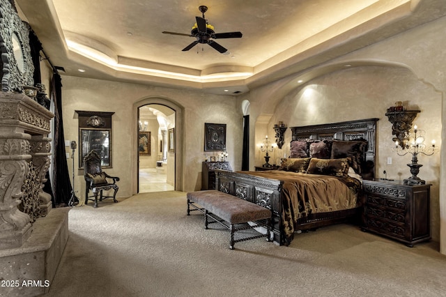 10894 E Turquoise Ave, Scottsdale, AZ 85259 - bedroom featuring arched walkways, carpet flooring, connected bathroom, and a tray ceiling