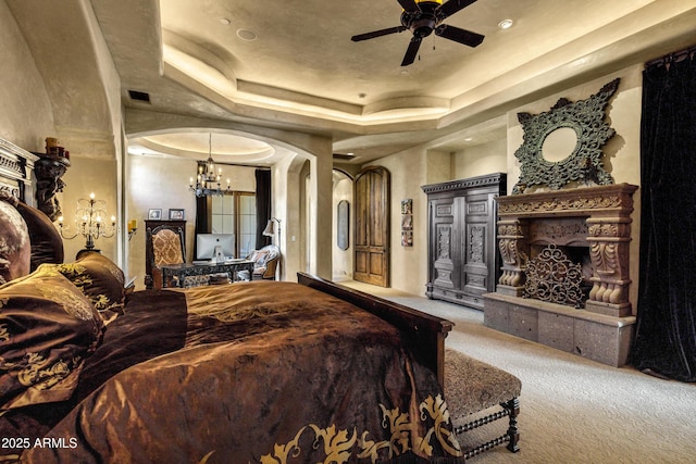 10894 E Turquoise Ave, Scottsdale, AZ 85259 - carpeted bedroom featuring a tray ceiling, arched walkways, an inviting chandelier, and visible vents