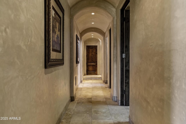 10894 E Turquoise Ave, Scottsdale, AZ 85259 - hallway with baseboards, arched walkways, lofted ceiling, and stone finish floor