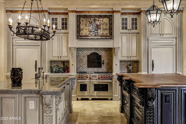 10894 E Turquoise Ave, Scottsdale, AZ 85259 - kitchen featuring stone finish flooring, butcher block countertops, range with two ovens, cream cabinets, and a notable chandelier