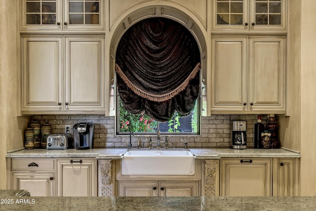 10894 E Turquoise Ave, Scottsdale, AZ 85259 - kitchen featuring cream cabinetry, backsplash, and a sink