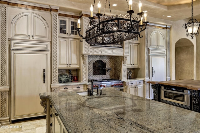 10894 E Turquoise Ave, Scottsdale, AZ 85259 - kitchen featuring a sink, tasteful backsplash, cream cabinets, and a chandelier