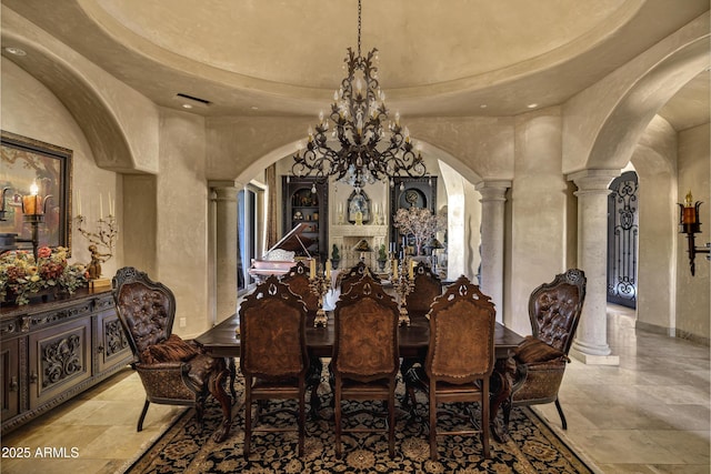 10894 E Turquoise Ave, Scottsdale, AZ 85259 - dining room featuring decorative columns, arched walkways, and a towering ceiling