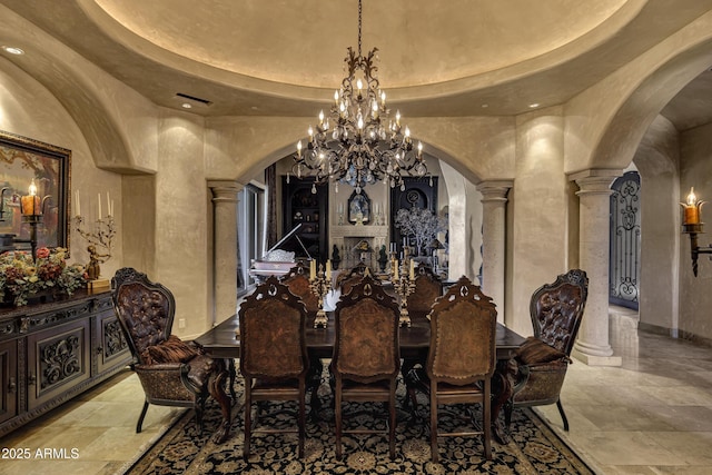 10894 E Turquoise Ave, Scottsdale, AZ 85259 - dining area with a tray ceiling, a notable chandelier, arched walkways, and ornate columns