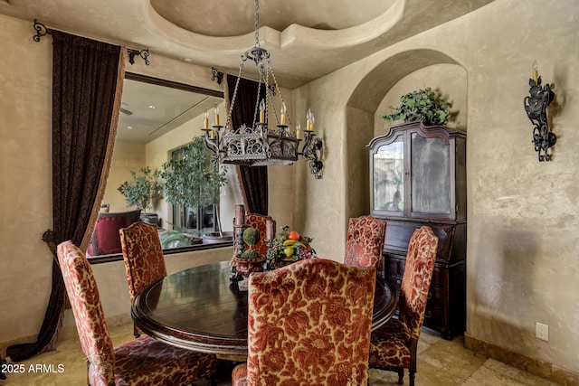 10894 E Turquoise Ave, Scottsdale, AZ 85259 - dining area with an inviting chandelier, arched walkways, and baseboards