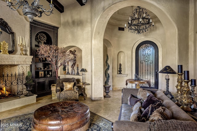 10894 E Turquoise Ave, Scottsdale, AZ 85259 - interior space featuring a high end fireplace, built in shelves, a towering ceiling, arched walkways, and a notable chandelier