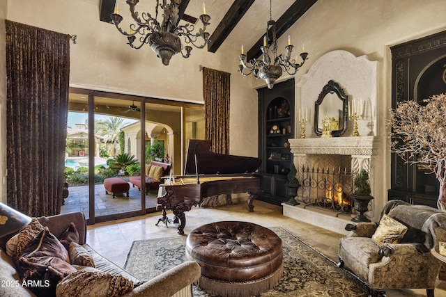 10894 E Turquoise Ave, Scottsdale, AZ 85259 - living area featuring built in shelves, beam ceiling, french doors, a towering ceiling, and a large fireplace