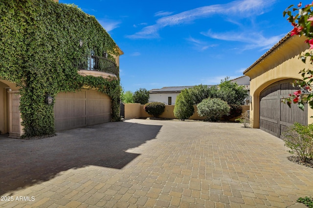 10894 E Turquoise Ave, Scottsdale, AZ 85259 - exterior space with a garage, decorative driveway, a balcony, and stucco siding