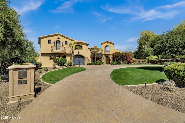 10894 E Turquoise Ave, Scottsdale, AZ 85259 - mediterranean / spanish-style house featuring curved driveway, a tile roof, a front yard, stucco siding, and a balcony