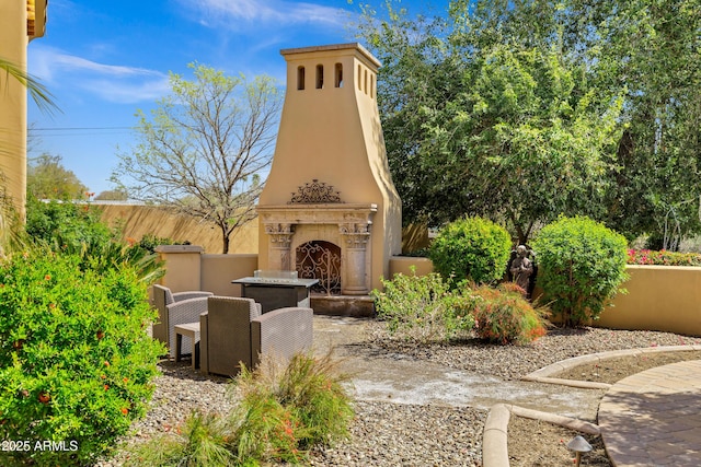 10894 E Turquoise Ave, Scottsdale, AZ 85259 - view of patio featuring an outdoor fireplace and fence