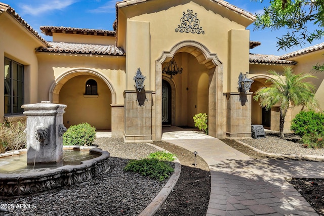 10894 E Turquoise Ave, Scottsdale, AZ 85259 - view of exterior entry with a tiled roof and stucco siding