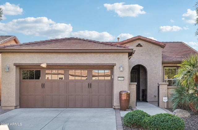 mediterranean / spanish home featuring a garage