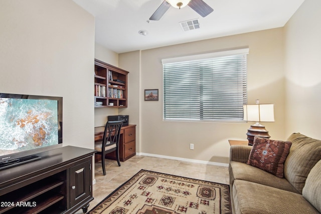 home office with ceiling fan and light tile patterned floors