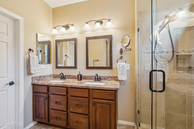 bathroom with vanity and a shower with shower door