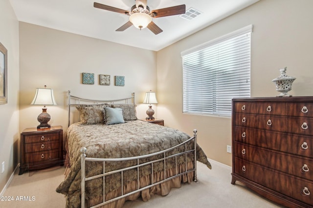 bedroom featuring ceiling fan and light carpet